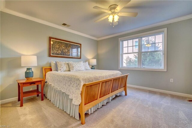 carpeted bedroom featuring ceiling fan and ornamental molding