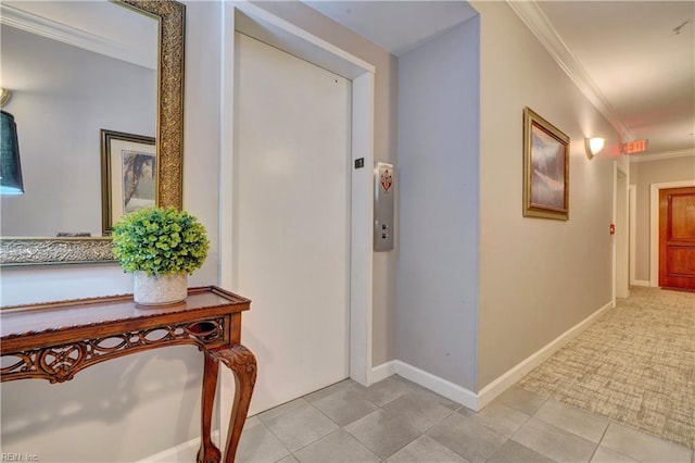 hall with elevator, ornamental molding, and light tile patterned flooring