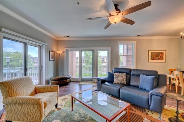 living room with ceiling fan with notable chandelier and ornamental molding