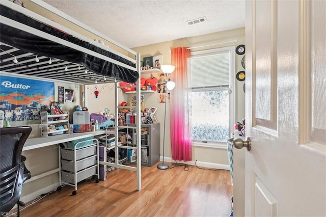 office space featuring hardwood / wood-style floors and a textured ceiling