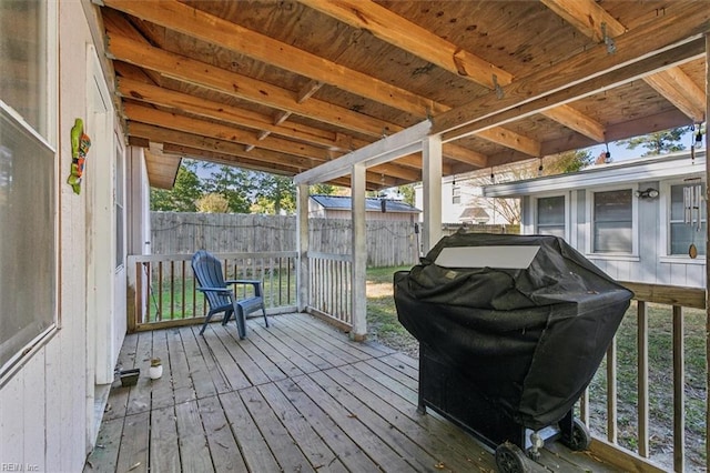 wooden deck featuring a grill