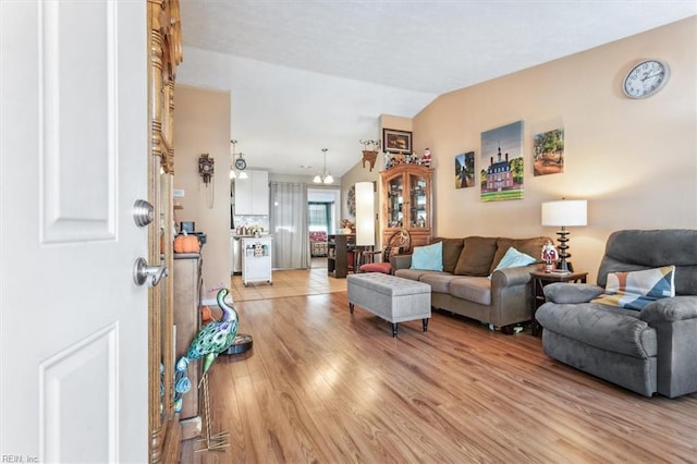 living room with vaulted ceiling and light hardwood / wood-style flooring