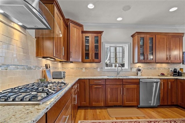 kitchen featuring wall chimney exhaust hood, sink, stainless steel appliances, and light hardwood / wood-style flooring