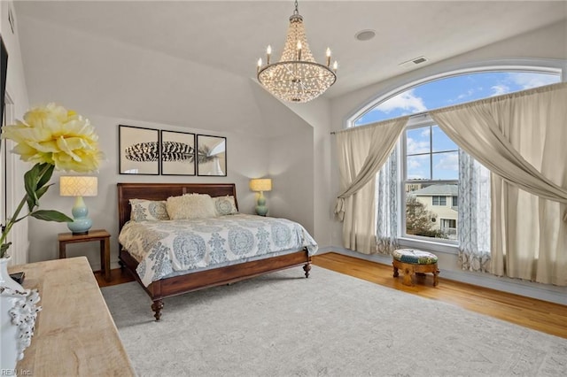 bedroom featuring a chandelier and hardwood / wood-style flooring