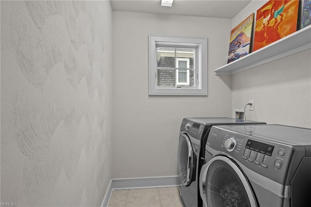 clothes washing area with separate washer and dryer and light tile patterned floors