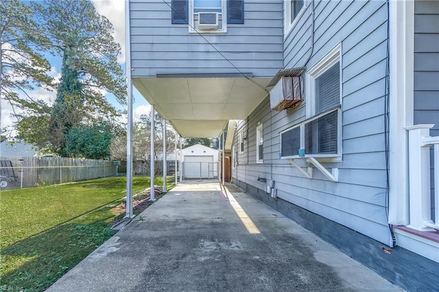 view of patio with a garage and an outbuilding