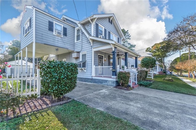 view of front of property featuring covered porch, cooling unit, and a front yard