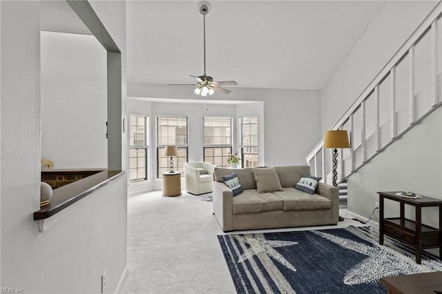 carpeted living room featuring ceiling fan and lofted ceiling