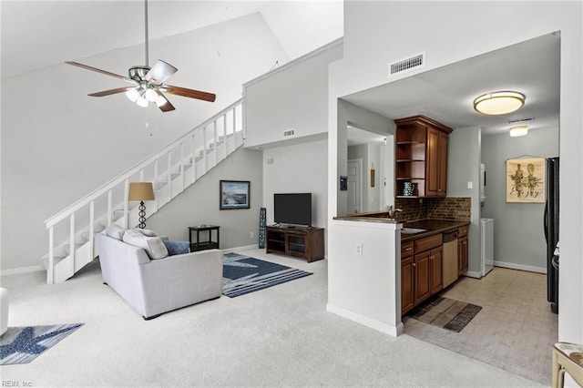 kitchen featuring dishwasher, high vaulted ceiling, sink, ceiling fan, and tasteful backsplash