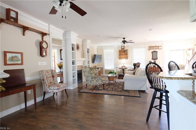 living room with ceiling fan, dark hardwood / wood-style flooring, and ornamental molding