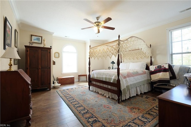 bedroom with dark hardwood / wood-style flooring, multiple windows, ornamental molding, and ceiling fan