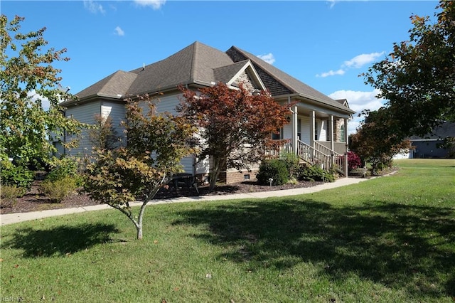 view of side of property featuring a porch and a yard