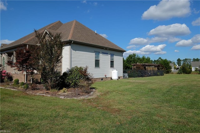 view of side of home with a lawn