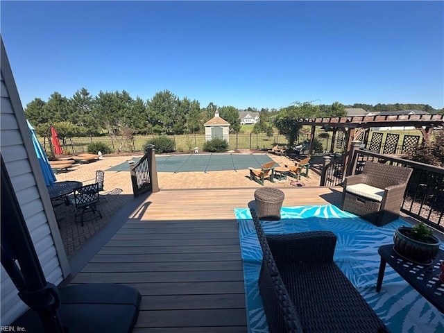 wooden terrace featuring a pergola and a covered pool