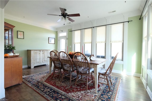 dining space with ceiling fan, plenty of natural light, ornamental molding, and hardwood / wood-style flooring