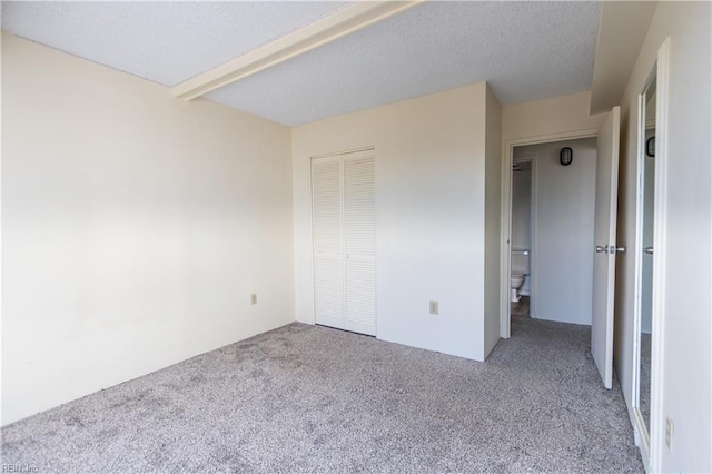 unfurnished bedroom with carpet and a closet