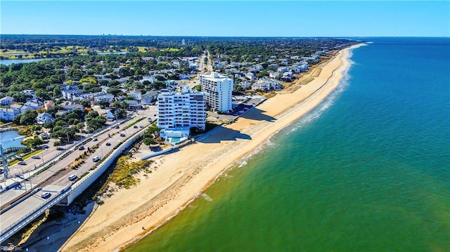 drone / aerial view featuring a water view and a beach view