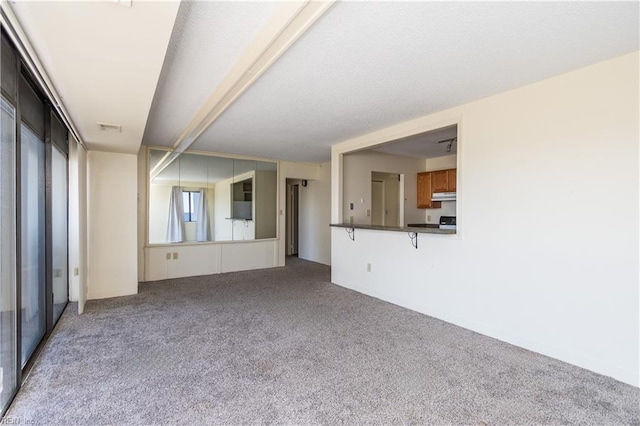 unfurnished living room featuring light carpet