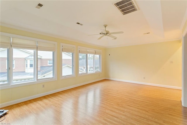 empty room featuring light wood-type flooring, ceiling fan, and crown molding