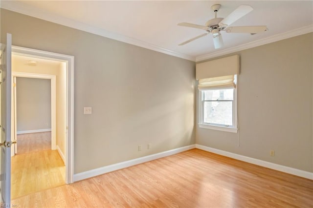 spare room with ceiling fan, light wood-type flooring, and crown molding