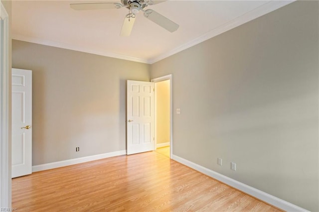 spare room with ceiling fan, ornamental molding, and light wood-type flooring