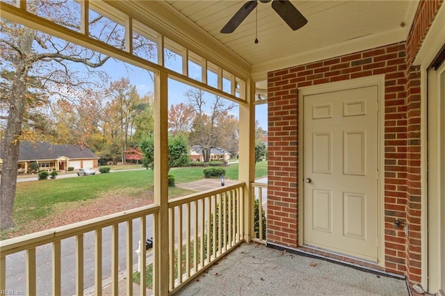 unfurnished sunroom with ceiling fan and wood ceiling