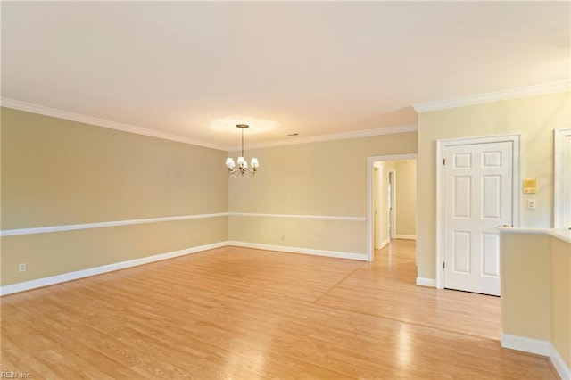 empty room with a notable chandelier, light wood-type flooring, and ornamental molding