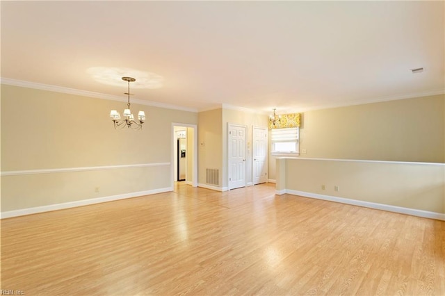 unfurnished room with crown molding, light hardwood / wood-style floors, and an inviting chandelier