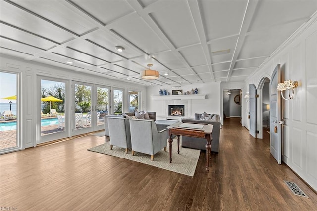 living room featuring coffered ceiling and hardwood / wood-style flooring