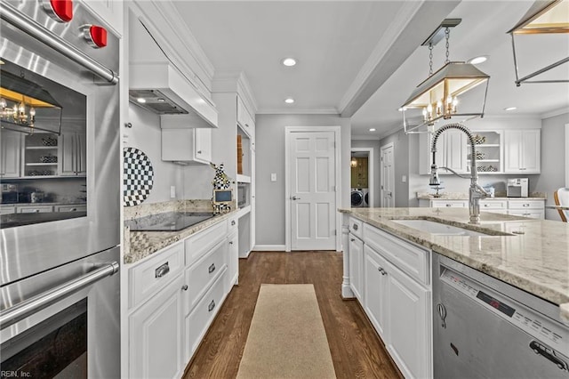 kitchen with white cabinets, dark hardwood / wood-style flooring, appliances with stainless steel finishes, and an inviting chandelier