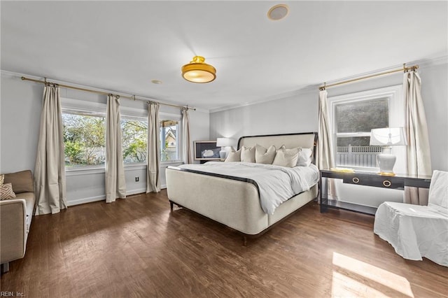 bedroom featuring ornamental molding and dark wood-type flooring