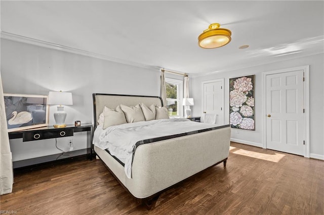 bedroom with dark hardwood / wood-style floors and ornamental molding