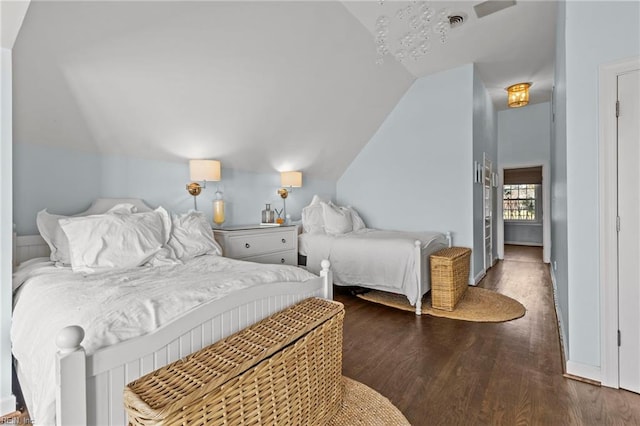 bedroom featuring dark hardwood / wood-style flooring and lofted ceiling