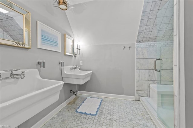 bathroom featuring tile patterned floors, a shower with shower door, sink, and vaulted ceiling