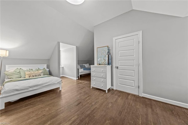 bedroom with dark hardwood / wood-style flooring and vaulted ceiling