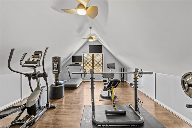 exercise room with ceiling fan, lofted ceiling, and hardwood / wood-style flooring