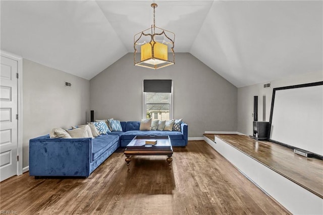 cinema with hardwood / wood-style flooring and vaulted ceiling