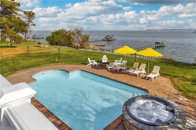 view of pool featuring a patio area, an in ground hot tub, a yard, and a water view