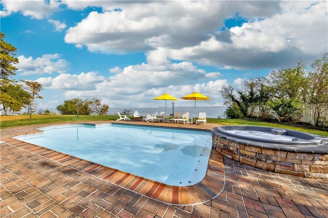 view of pool with an outdoor hot tub, a yard, and a patio