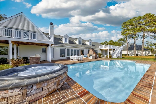 view of pool featuring a wooden deck and a hot tub