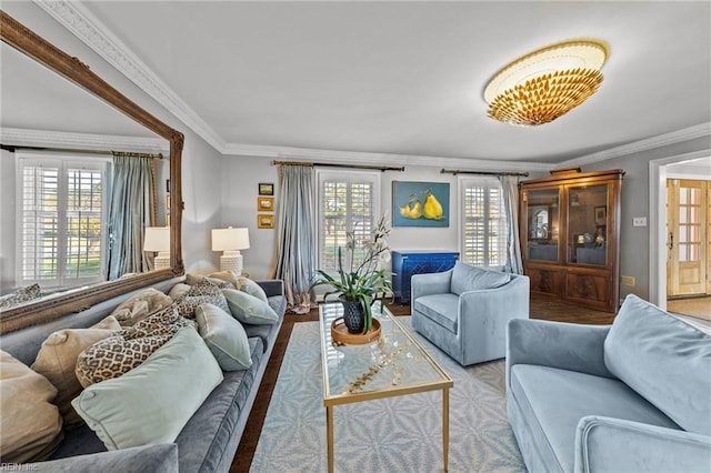 living room with plenty of natural light, crown molding, and light hardwood / wood-style flooring