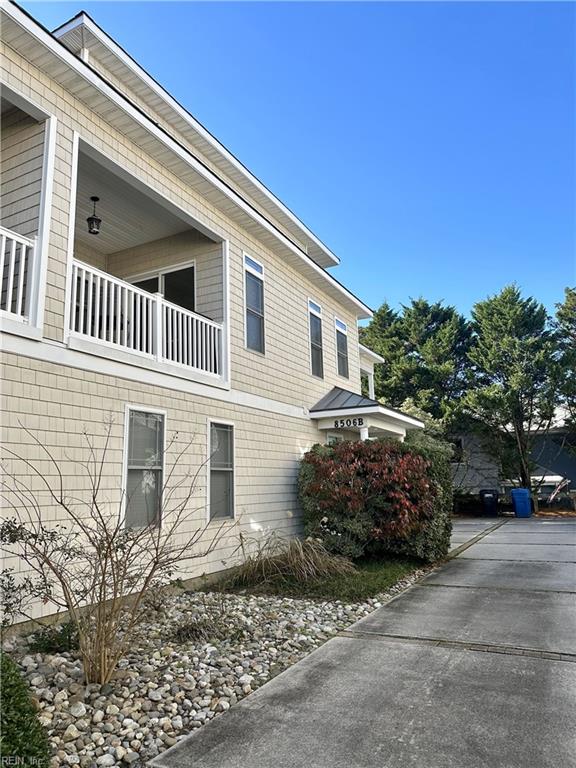 view of side of home featuring a balcony