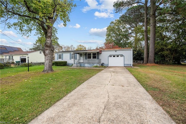 view of front facade with a porch, a garage, and a front lawn