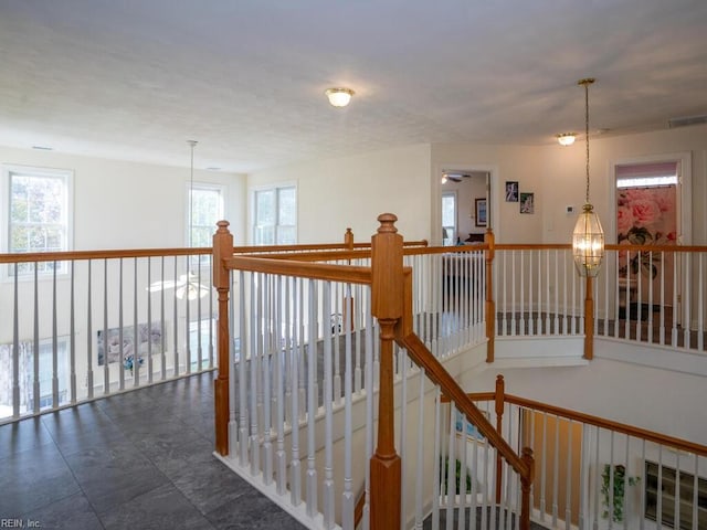 hall featuring a chandelier