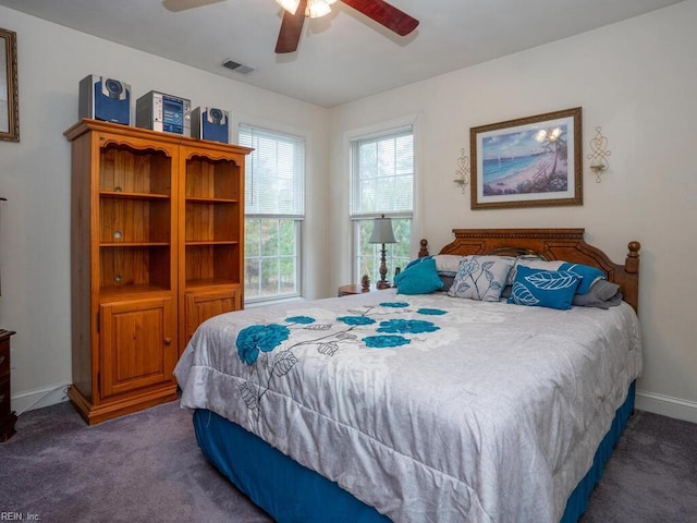 bedroom with ceiling fan and dark carpet