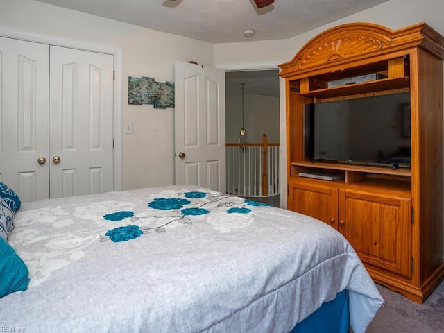 carpeted bedroom featuring a closet and ceiling fan