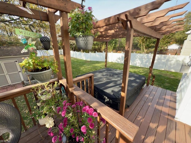 deck with a pergola, a covered hot tub, and a lawn