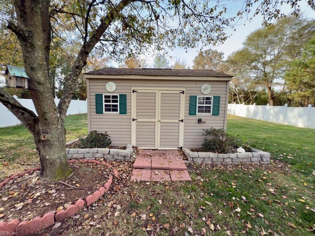 view of outdoor structure featuring a lawn