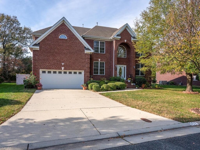 view of front of property with a front yard and a garage