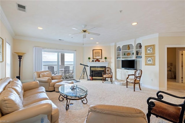 living room with ceiling fan, light colored carpet, and crown molding